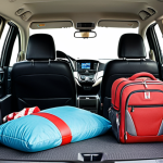 **Prompt:** Interior of a Honda CR-V, spacious cabin with comfortable seating and ample legroom. Luggage and vacation items are neatly packed in the cargo area. Focus on a happy family enjoying the space. Malaysian family context.